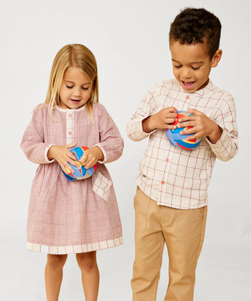 Boy and girl holding surprise balls wearing Burgundy Check Dress and Shirt