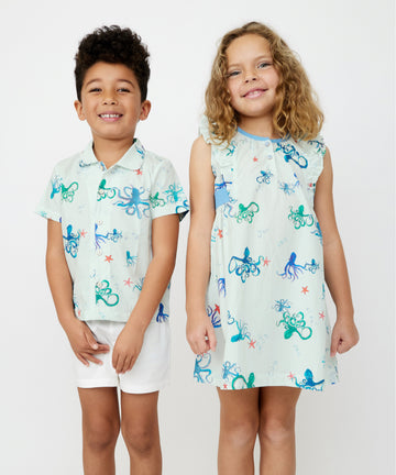 Boy and girl in matching Octopus Friends print dress in studio shoot