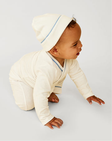 Baby crawling wearing Crossbody One-Piece, Hazy Hat, and Andy Baby Leggings