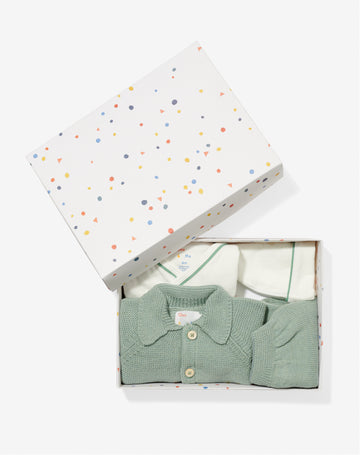 Gift box open with Crossbody One-piece, Hazy Hat, Pat Jacket, and Baker Pants inside